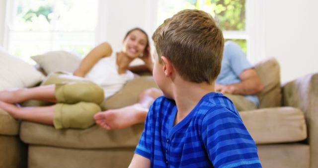 Young Boy Sitting on Floor at Home Watching Family Conversation - Download Free Stock Images Pikwizard.com