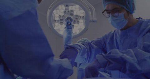 Surgeons Performing Precise Operation Under Surgical Light