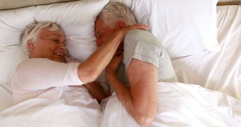 Senior couple enjoying relaxed morning in bed