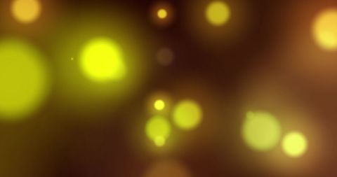 Floating Yellow Glow Lights on Dark Background
