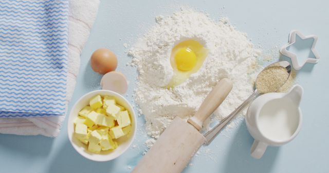 Image of baking ingredients, muffin papers, eggs and tools lying on white surface. baking, food preparing, taste and flavour concept.