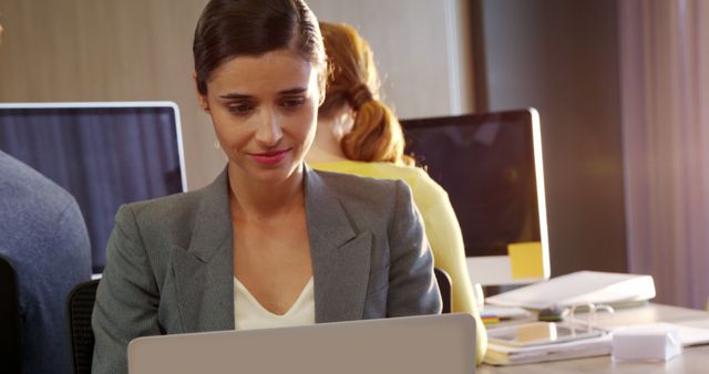 Professional Businesswoman Working on Laptop in Modern Office Environment - Download Free Stock Images Pikwizard.com