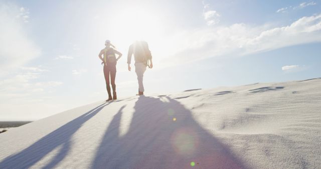 Adventurous Hikers on Bright Sunny Day in Desert dunes - Download Free Stock Images Pikwizard.com