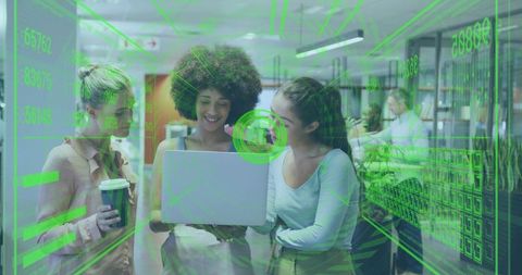 Three coworkers collaborating over laptop with futuristic green hud overlay in office