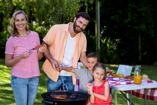 Family enjoying a sunny day while grilling food in their backyard. Parents and children are smiling and interacting around the barbecue grill. Perfect for concepts related to family bonding, outdoor activities, summer fun, and casual dining. Ideal for advertisements, lifestyle blogs, and promotional materials for outdoor products or family-oriented services.