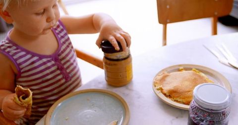 Young Girl Enjoying Breakfast at Home