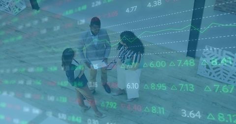 Top-down team collaborating over tablet with financial market data overlay