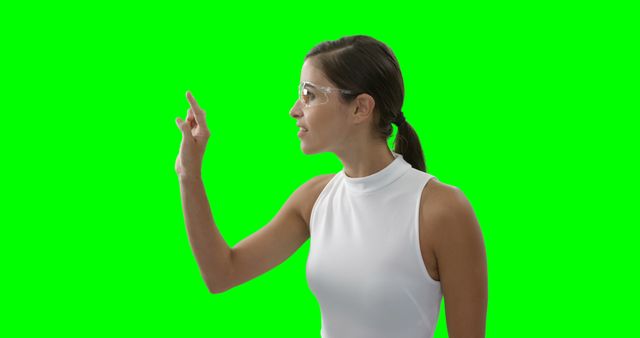 Woman in Safety Goggles Pointing Upwards on Green Screen Background - Download Free Stock Images Pikwizard.com