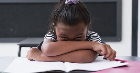Young girl resting during school study time in classroom