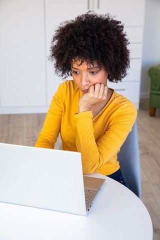 Young Woman Working on Laptop at Home in Bright Modern Environment