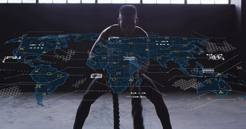 Male athlete training with battle ropes and futuristic global data overlay