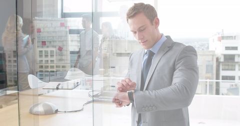 Businessman Checking Time in Modern Office Environment - Download Free Stock Images Pikwizard.com