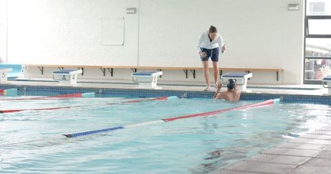 Coach Training Swimmer Indoors in Professional Lap Pool - Download Free Stock Images Pikwizard.com