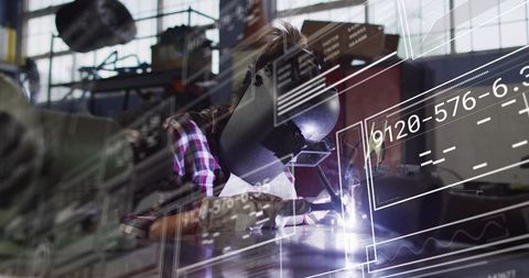Welder welding steel using TIG torch and helmet with HUD overlay in industrial workshop
