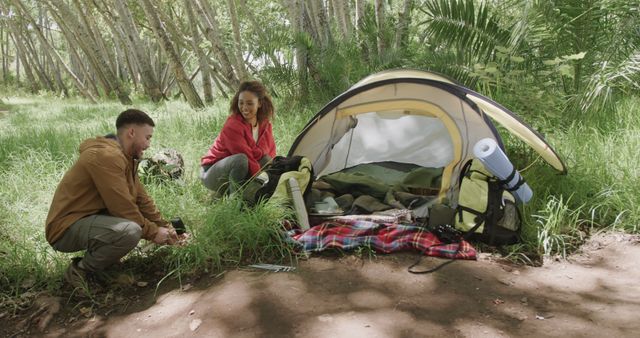 Young Couple Setting Up Tent in Lush Forest - Download Free Stock Images Pikwizard.com