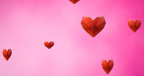 Geometric Hearts Falling on Pink Background for Romantic Celebration