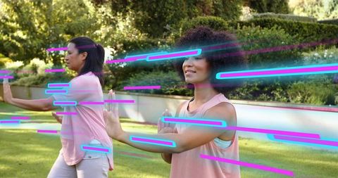 Practicing tai chi in garden with neon motion streaks, women doing slow martial arts