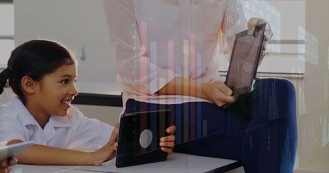 Digital Learning Concept with Teacher Mentoring Student on Tablet