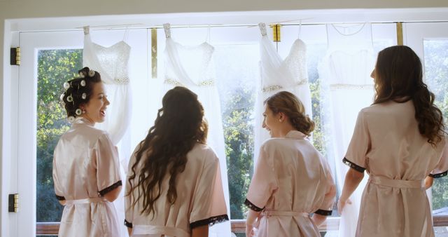 Bridesmaids and bride preparing for wedding with dresses in the background - Download Free Stock Images Pikwizard.com