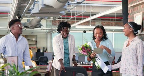 Diverse Team Celebrating Success with Flowers in Modern Office