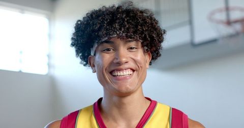 Smiling Athlete in Basketball Jersey Exudes Confidence