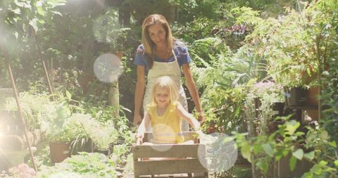 Mother and daughter enjoying a sunny day in lush garden