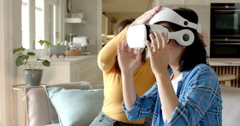 Women Adjusting VR Headset in Modern Living Room