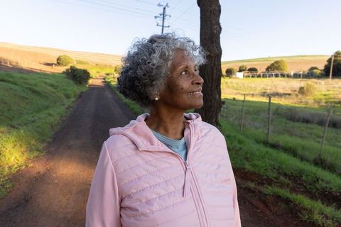 Senior Woman Enjoying Peaceful Countryside Stroll