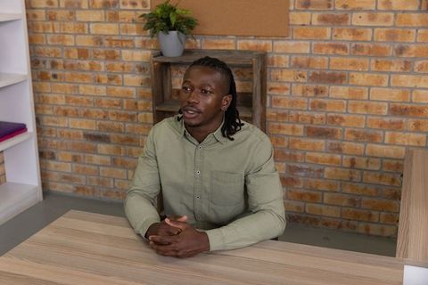 Professional man speaking at desk in modern office setting