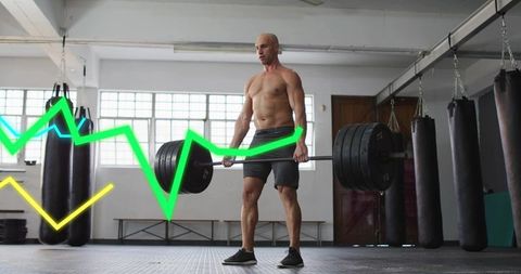 Muscular athlete deadlifting heavy barbell in industrial gym with neon performance graph