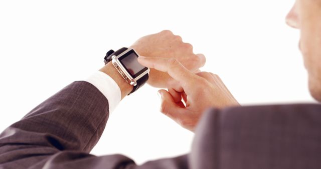 A Caucasian businessman is checking the time or notifications on his smartwatch, with copy space - Download Free Stock Photos Pikwizard.com
