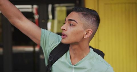 Young Traveler Raising Hand in Urban Street Adventure