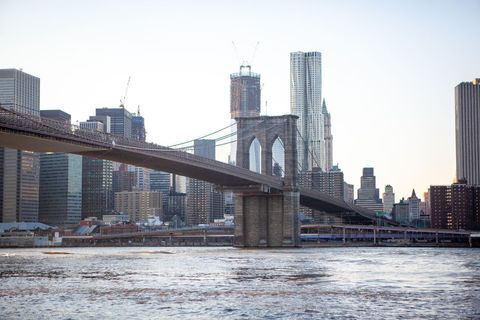 Early morning view of iconic road brooklyn bridge and new york city skyline