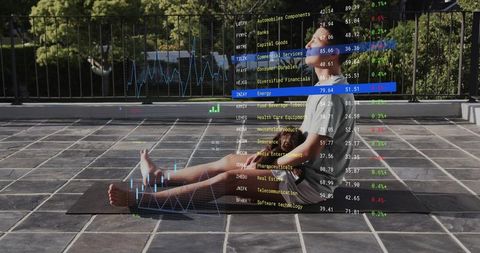 Asian man stretching on rooftop yoga mat with financial data overlay, wellness tech fusion