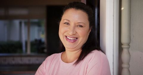Smiling Mature Woman Relaxing Indoors at Home