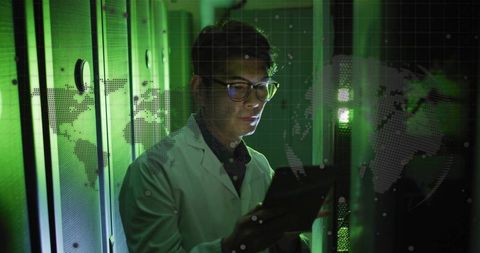 Korean IT technician inspecting server rack with tablet, holographic world map overlay
