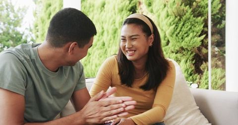 Happy Couple Exchanging Gifts on Patio in Relaxed Atmosphere