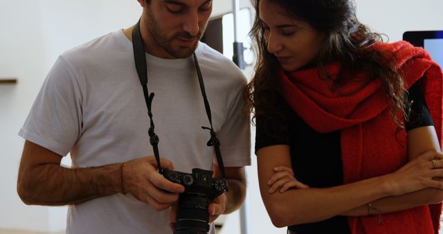 Photographer Showing Images to Woman in Studio - Download Free Stock Images Pikwizard.com