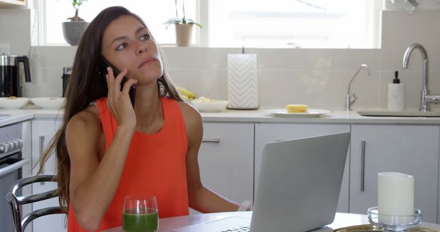 Young Woman Working from Home Using Laptop and Talking on Phone - Download Free Stock Images Pikwizard.com