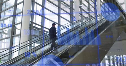 Businessman Analyzing Data Using Smartphone on Office Escalator