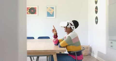 Woman Using VR Headset at Home for Immersive Experience
