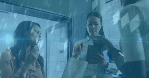 Women Collaborating in Modern Office with Digital Data Overlay