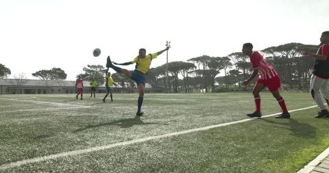 Intense Soccer Game on Sunlit Field with Athletes Competing