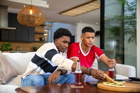 Diverse Friends Enjoying Pizza in Modern Living Room Setting