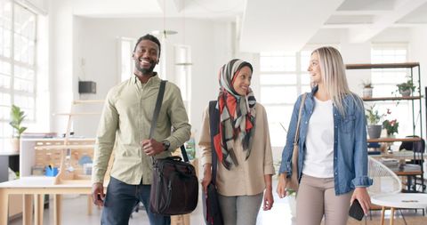 Diverse Team of Colleagues Walking and Smiling in Modern Office Space - Download Free Stock Images Pikwizard.com