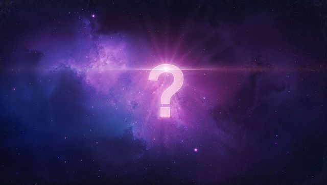 Glowing question mark in mystical outer space with nebula and lens flare