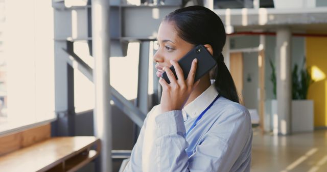 Confident Businesswoman Talking on Phone in Modern Office Environment - Download Free Stock Images Pikwizard.com