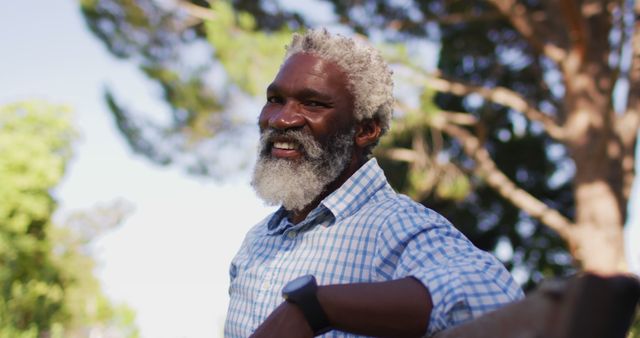 Smiling Elderly Man Relaxing in Park on Sunny Day - Download Free Stock Images Pikwizard.com