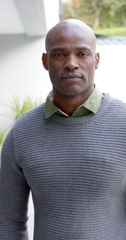 Confident man in casual sweater enjoying urban outdoor setting