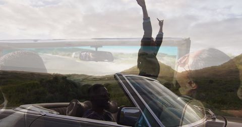 Couples Embracing Freedom in Convertible Over Panoramic Landscape
